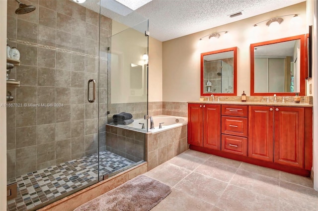 bathroom featuring separate shower and tub, tile patterned flooring, vanity, and a textured ceiling