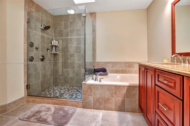 bathroom with tile patterned flooring, vanity, shower with separate bathtub, and a textured ceiling