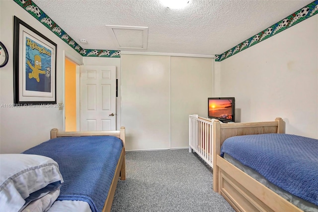 carpeted bedroom featuring a textured ceiling