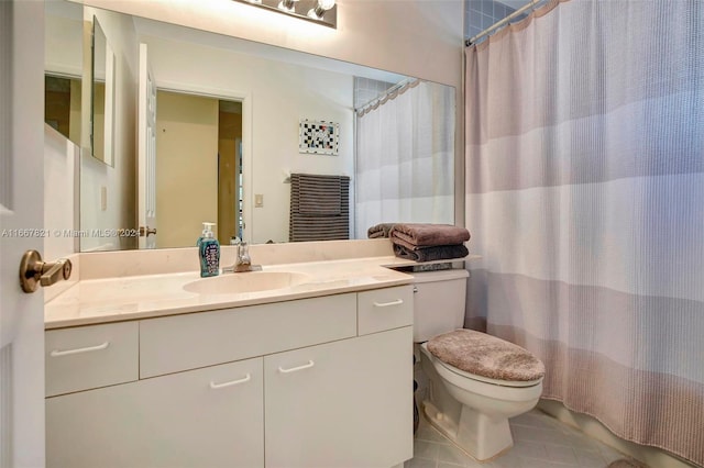 bathroom featuring tile patterned flooring, vanity, and toilet