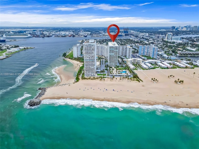 bird's eye view featuring a view of the beach and a water view