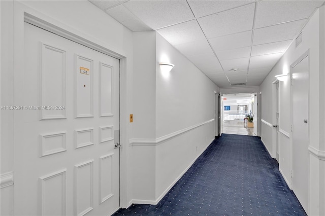 corridor with a paneled ceiling