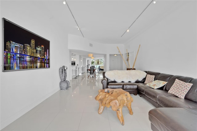 living room with tile patterned floors and track lighting