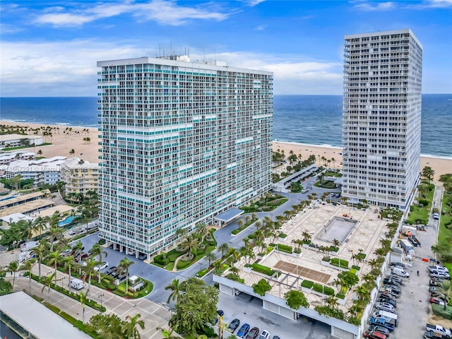 drone / aerial view with a water view and a view of the beach