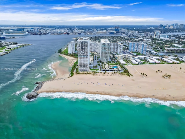 drone / aerial view featuring a beach view and a water view