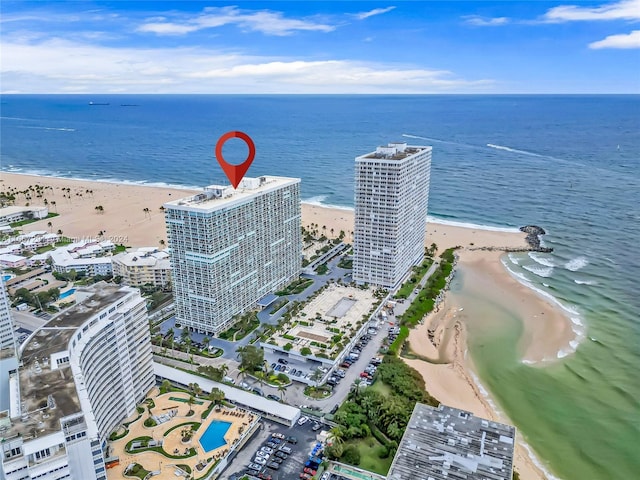 drone / aerial view featuring a water view and a view of the beach