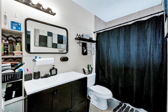 bathroom featuring vanity, tile patterned flooring, toilet, and curtained shower