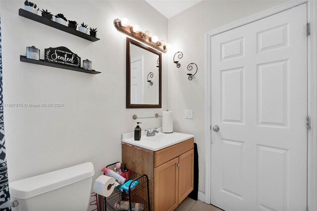 bathroom featuring vanity and toilet