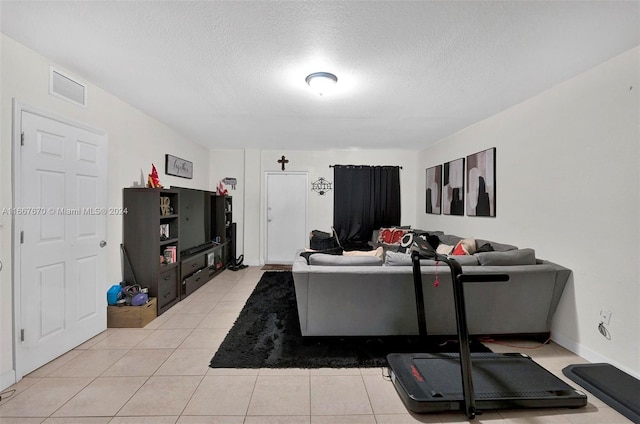 living room featuring a textured ceiling and light tile patterned flooring