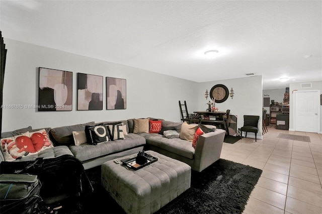 tiled living room with a textured ceiling