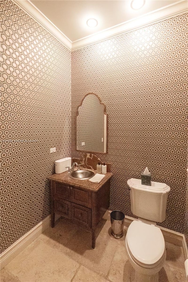 bathroom featuring ornamental molding, toilet, and vanity