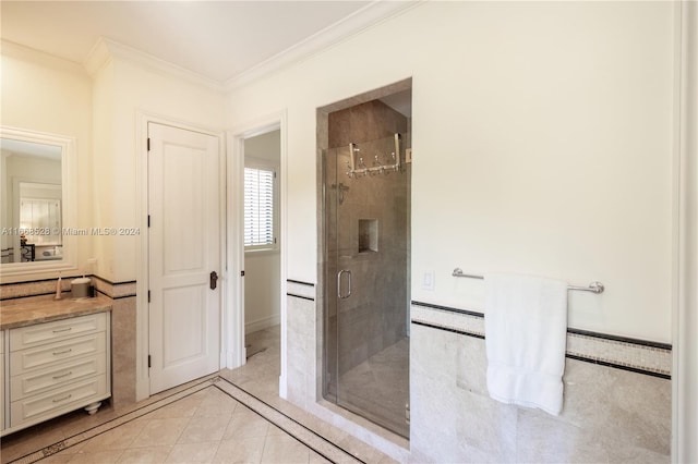 bathroom featuring tile patterned flooring, a baseboard radiator, a shower with shower door, ornamental molding, and vanity