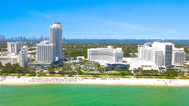 property's view of city featuring a water view and a beach view