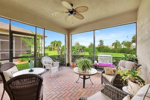 sunroom / solarium featuring ceiling fan