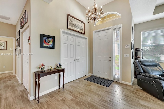 foyer entrance with a notable chandelier