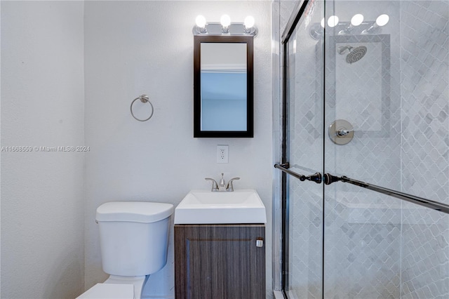 bathroom with vanity, toilet, and walk in shower