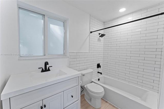 full bathroom with vanity, tiled shower / bath combo, and toilet