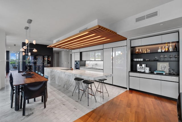 dining area featuring light hardwood / wood-style flooring and sink