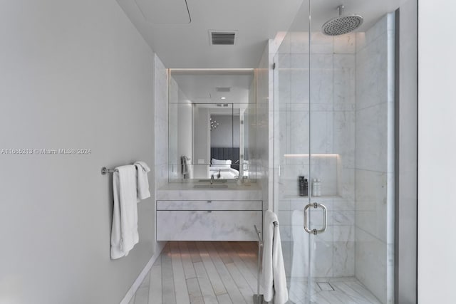 bathroom featuring vanity and a shower with shower door