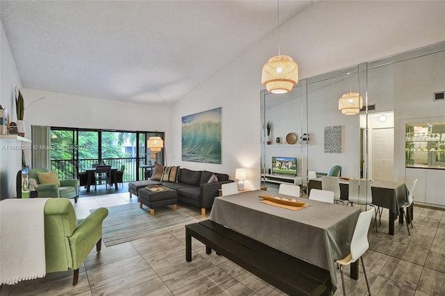 dining room with high vaulted ceiling