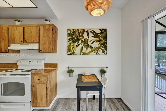 kitchen with white electric range oven and light hardwood / wood-style flooring