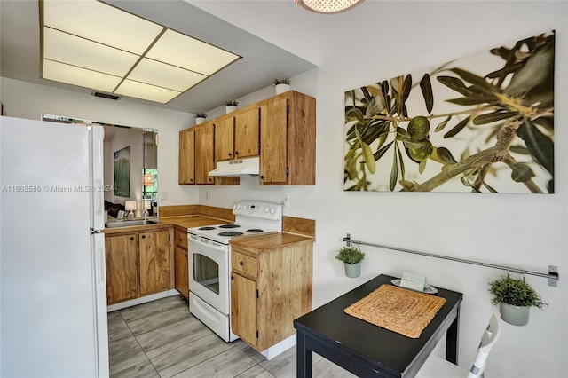 kitchen featuring light hardwood / wood-style flooring and white appliances