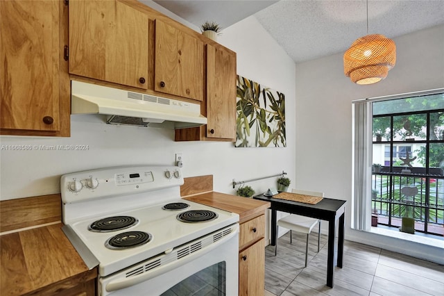 kitchen with a textured ceiling, light tile patterned flooring, white range with electric cooktop, and pendant lighting