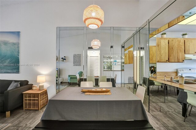 dining space with hardwood / wood-style flooring and sink