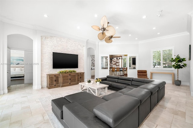 living room featuring crown molding and ceiling fan