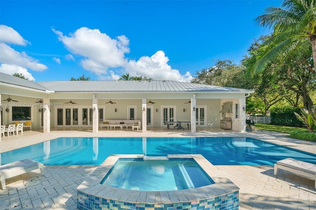 view of pool featuring an outdoor living space, french doors, ceiling fan, an in ground hot tub, and a patio area