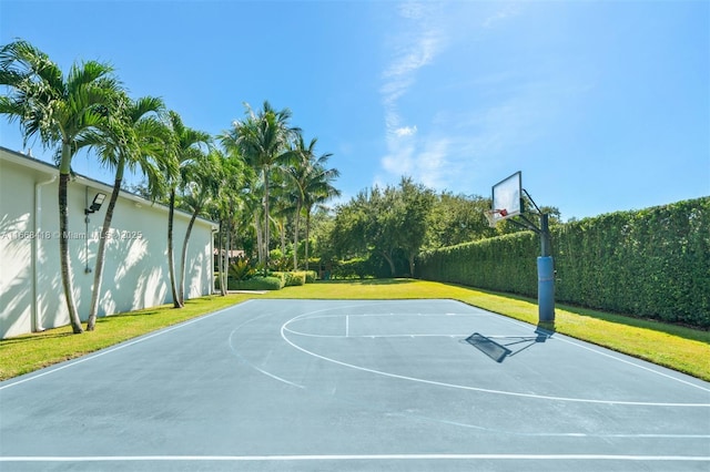 view of basketball court with a yard