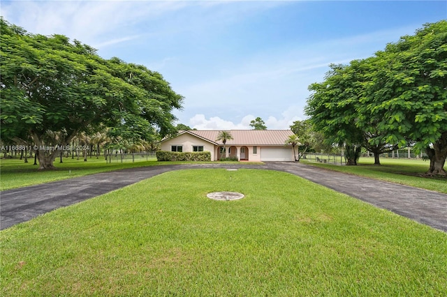 view of front of home with a garage and a front lawn