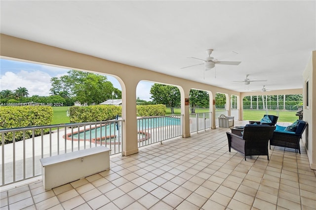 view of patio featuring a fenced in pool and ceiling fan