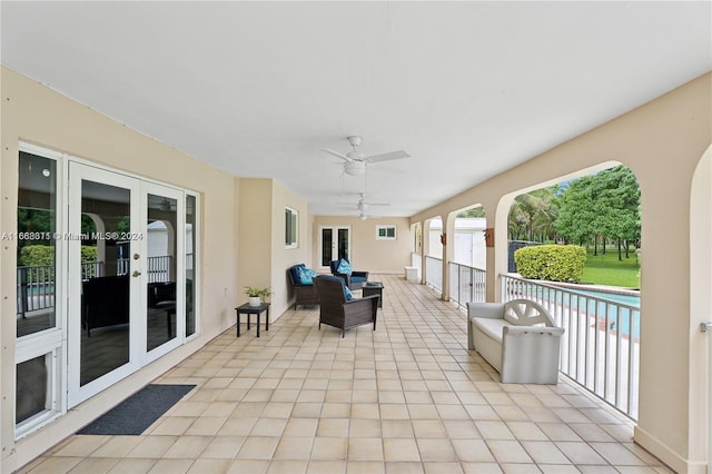 view of patio featuring ceiling fan, outdoor lounge area, and french doors