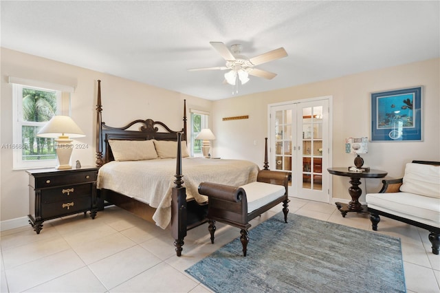 tiled bedroom featuring ceiling fan and french doors