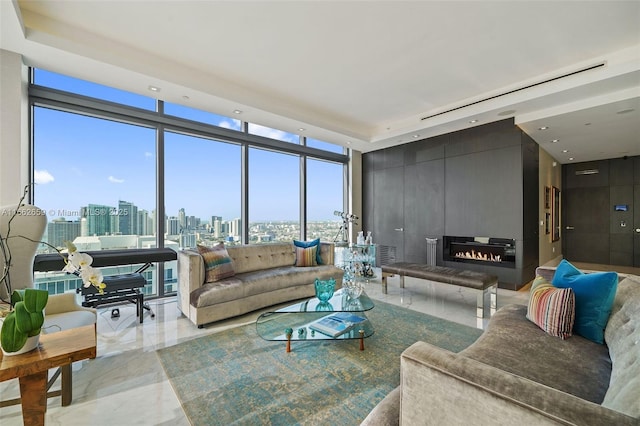 living room with expansive windows, a healthy amount of sunlight, and a fireplace