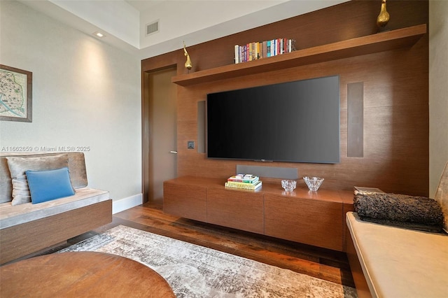 living room featuring dark hardwood / wood-style floors and built in features