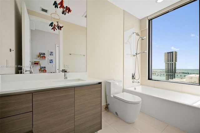 bathroom featuring tile patterned flooring, vanity, a wealth of natural light, and toilet