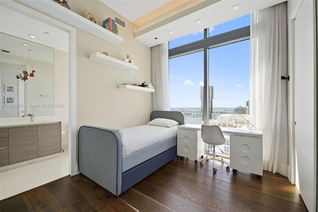 bedroom with sink and dark hardwood / wood-style flooring