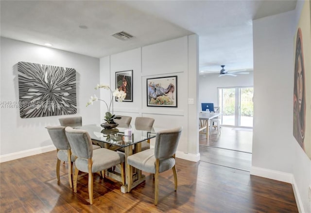 dining space with ceiling fan and dark hardwood / wood-style flooring