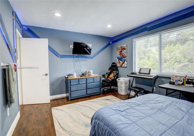 bedroom with dark wood-type flooring