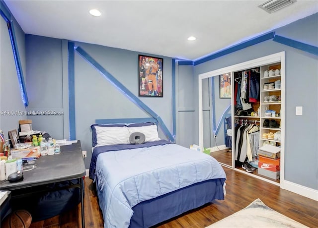 bedroom with a closet and dark hardwood / wood-style flooring