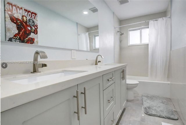 full bathroom with shower / tub combo with curtain, vanity, and toilet