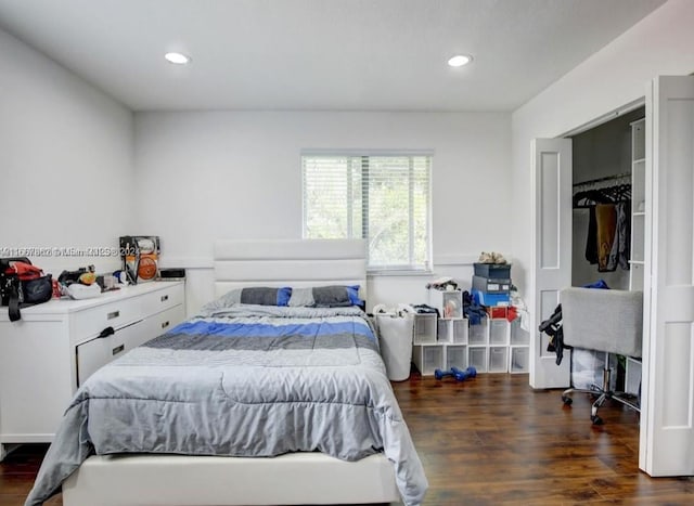 bedroom with a closet and dark hardwood / wood-style floors