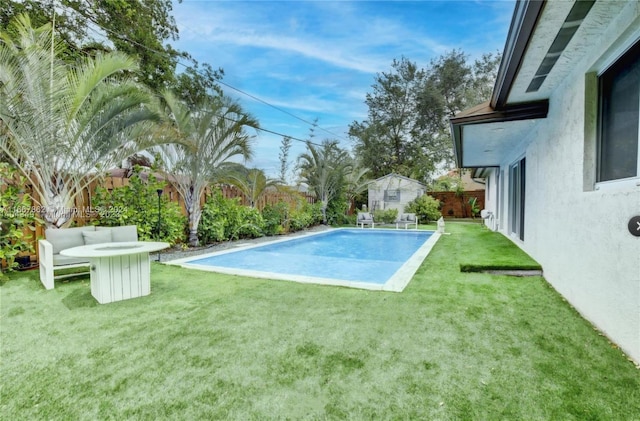 view of swimming pool with a yard