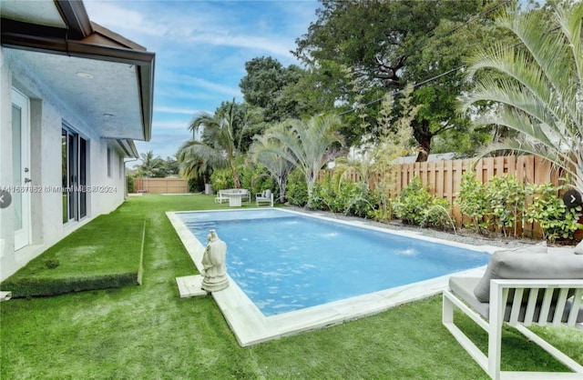 view of pool featuring a yard