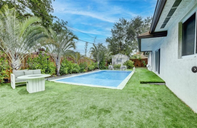 view of swimming pool with outdoor lounge area and a lawn