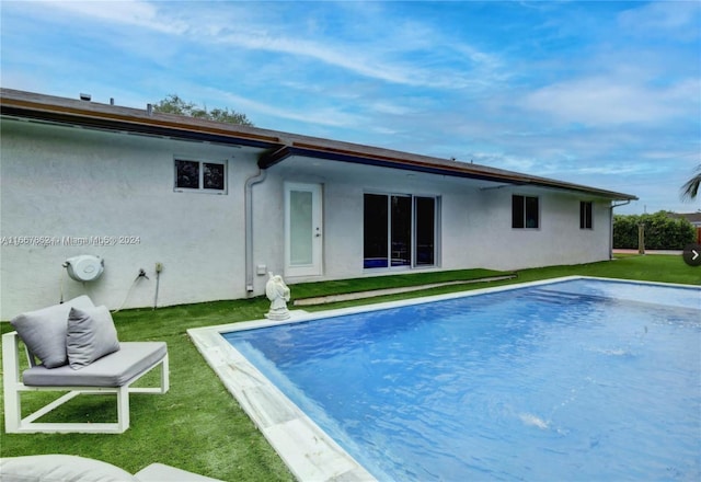 rear view of house featuring a lawn