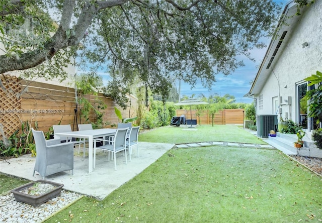 view of yard featuring central AC unit and a patio area