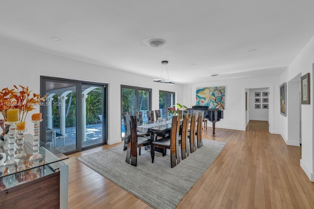 dining space with light wood-type flooring